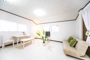 a living room with a couch and a table at 9 min to Yokkaichi Tomida STN House - Vacation STAY 14165 in Yokkaichi