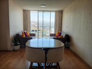 a living room with a table and chairs and a window at Hampiwasi in Miraflores