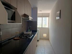 a kitchen with a stove and a counter top at Hampiwasi in Miraflores