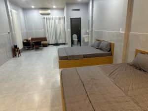 a bedroom with two beds and a living room at Happy House Sài Gòn in Ho Chi Minh City +28 photos