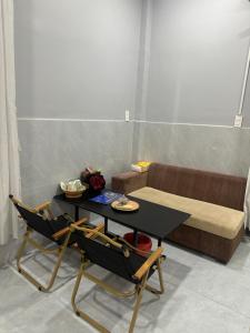 a living room with a table and a couch at Happy House Sài Gòn in Ho Chi Minh City