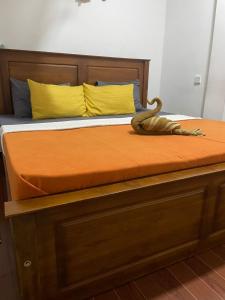 a bed with an alligator sitting on top of it at The Ceylan Crest Hotel Ella in Ella