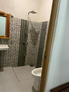 a bathroom with a shower with a toilet and a sink at The Ceylan Crest Hotel Ella in Ella