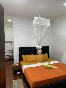 a bedroom with a bed with bananas on it at The Ceylan Crest Hotel Ella in Ella