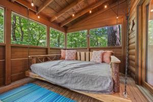 a bed in a room in a log cabin at Cozy cabin, Bed swing, Arcade game, hot tub in Sevierville