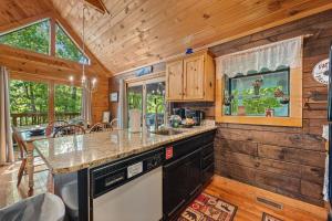 a kitchen with a counter top in a cabin at Cozy cabin, Bed swing, Arcade game, hot tub in Sevierville