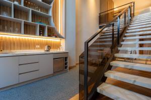 a staircase leading to the kitchen and dining room of a house at Alko Hotel Integrado in Cali