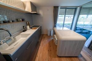 a kitchen with a sink and a counter top at Sou in Isahaya +28 photos