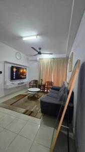 a living room with a couch and a tv at Alanis Suite KLIA With Neflix in Sepang