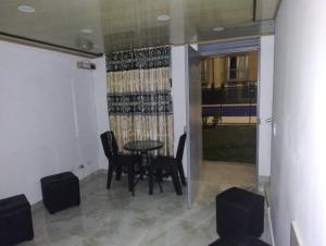 a dining room with a table and chairs and a window at Casa ubicada en zona campestre de Ibagué in Ibagué +18 photos
