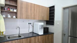 a kitchen with a sink and a white appliance on a counter at Alanis Suite KLIA With Neflix in Sepang +28 photos