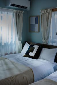 Ένα ή περισσότερα κρεβάτια σε δωμάτιο στο Casa YONNA Chatan