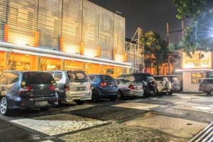 a row of cars parked in front of a building at Gandasari Hotel in Bandung