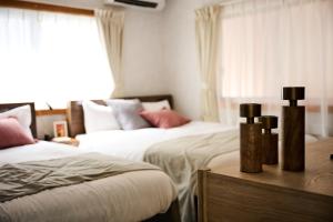 Ένα ή περισσότερα κρεβάτια σε δωμάτιο στο Casa YONNA Chatan