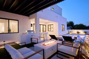 a living room with white furniture and a fire pit at Sunrift-Private Pool & Spa-Walk to Old Town in Scottsdale