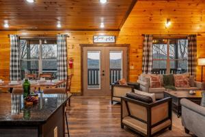a living room with wooden walls and wooden floors at Views, Arcade Game, Fire-pit, Hot Tub, Private! in Sevierville
