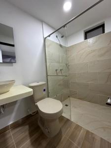 a bathroom with a toilet and a glass shower at Hotel Oro VIP Pereira in Pereira +51 photos
