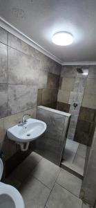 a bathroom with a sink and a shower at Cooper in Potchefstroom