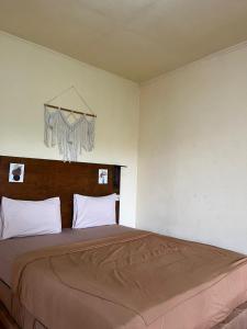 a bedroom with a large bed in a room at Dragonfly Senaru Lodge in Senaru