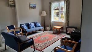 a living room with chairs and a couch and a window at The Tussocks, Arthur's Pass in Arthur's Pass
