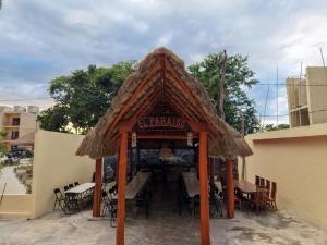a gazebo with tables and chairs in a building at Hotel El Paraíso Calakmul in Xpujil +12 photos