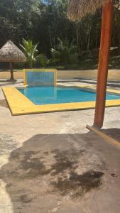 a swimming pool with a yellow and blue at Hotel El Paraíso Calakmul in Xpujil