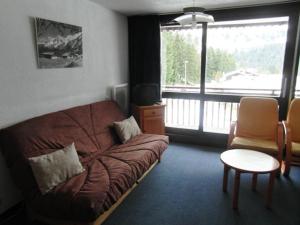 ein Wohnzimmer mit einer Couch vor einem Fenster in der Unterkunft Sublime appartement au cœur du Praz de Lys pour 5 pers, proche commerces et pistes ! - FR-1-815-17 in Le Praz de Lys + 2 Fotos