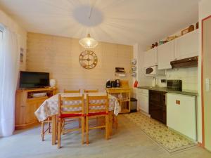 eine Küche mit Tisch und Stühlen in einem Zimmer in der Unterkunft Appartement charmant au cœur de Les Rousses - FR-1-834-15 in Les Rousses