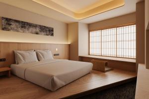 Ένα ή περισσότερα κρεβάτια σε δωμάτιο στο Hotel Fork & Knife Miyajima