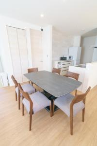 a dining room with a table and chairs at Burikina Terrace in Nago