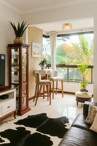 a living room with a couch and a table at Refúgio Campodoro in Florianópolis