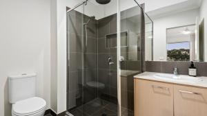 a bathroom with a shower and a toilet and a sink at Regal Retreat in Saint Leonards +12 photos