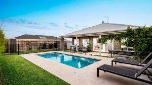 a swimming pool in the backyard of a house at Regal Retreat in Saint Leonards