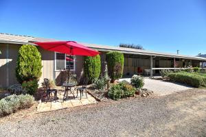 a house with a table and a red umbrella at Wine Country Ranch Escape in Buellton