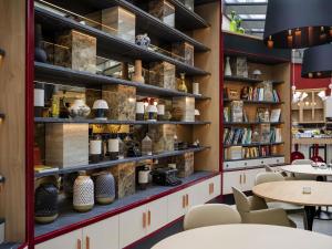 a room with tables and shelves with vases at Aparthotel Adagio Zurich City Center in Zürich
