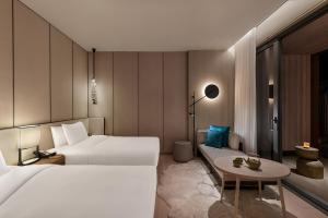 a hotel room with two beds and a table at Hotel Indigo Anji by IHG in Anji +81 photos