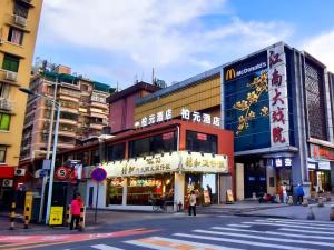 a city street with buildings and a crosswalk at Baiyuan Hotel Changgang Baogang Avenue Metro Station Branch in Guangzhou +15 photos