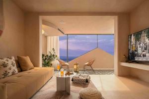 a living room with a couch and a large window at Dali Xiahe villa Seaview Hotel in Dali Airport