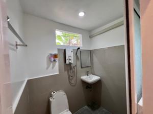 a small bathroom with a toilet and a sink at The Green Resort in Ko Chang