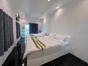 a bedroom with a large white bed in a room at The Green Resort in Ko Chang