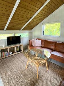 a living room with a couch and a coffee table at Kalmar House On Fejø Near The Beach in Vesterby