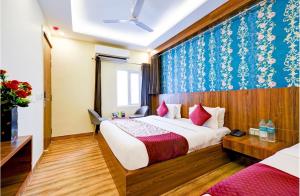 a hotel room with a bed and a blue and white wallpaper at Hotel Red Plaza -Near Delhi Airport & Free Airport Drop in New Delhi +45 photos