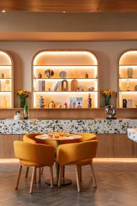 a dining room with a table and chairs at Cheval Maison - The Palm in Dubai