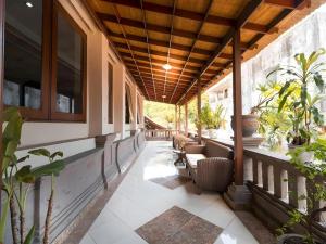 a porch with chairs and potted plants on it at Maha Jaya Hotel Bali in Denpasar