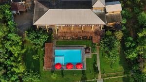 an overhead view of a house with a swimming pool at Chaarya Lake in Tissamaharama