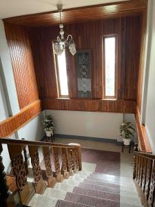 a staircase in a house with two windows at Chiangdaoinnhotel โรงแรมเชียงดาวอินน์ in Chiang Dao