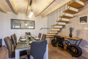 a dining room with a table and a motorcycle on the wall at Casa Cassianus - Happy Rentals in Sveti Petar u Šumi