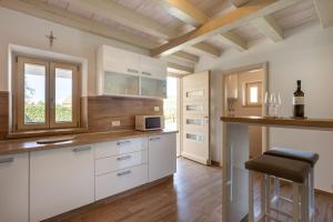 a kitchen with white cabinets and a window at Casa Cassianus - Happy Rentals in Sveti Petar u Šumi +36 photos