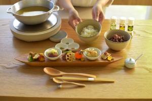 a table with a plate of food and bowls of food at 住 京都小川生薬 VILLA Jyu KyotoOgawaSyouyaku VILLA in Kyoto