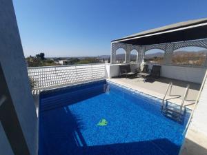 a swimming pool on the roof of a building at Casa Mía Morelos in Chiconcuac
